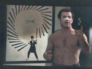 Mel Gibson with CYRK poster in What Women Want